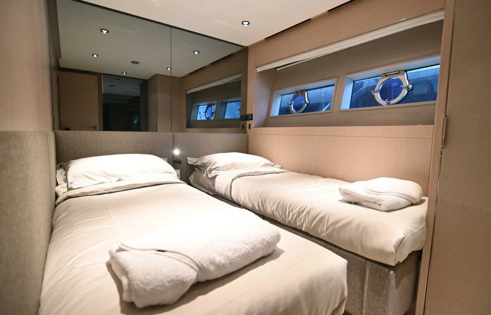 a room with three beds aboard JOYOUS JOURNEY Yacht for Sale