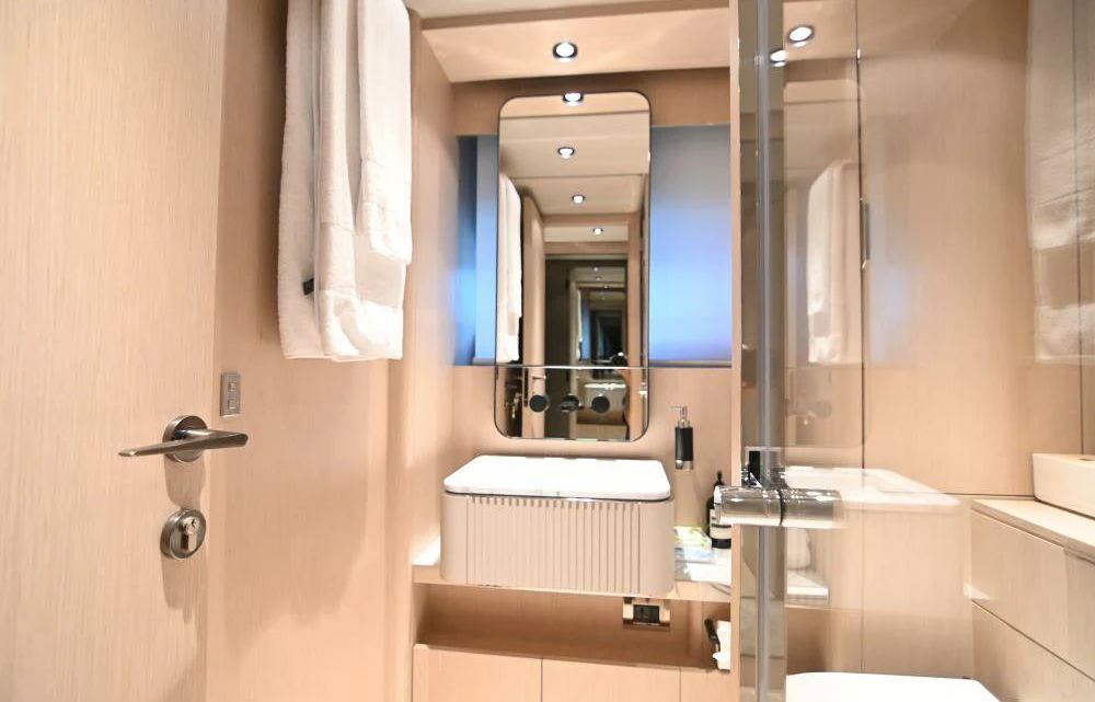 a bathroom with a mirror and a sink aboard JOYOUS JOURNEY Yacht for Sale