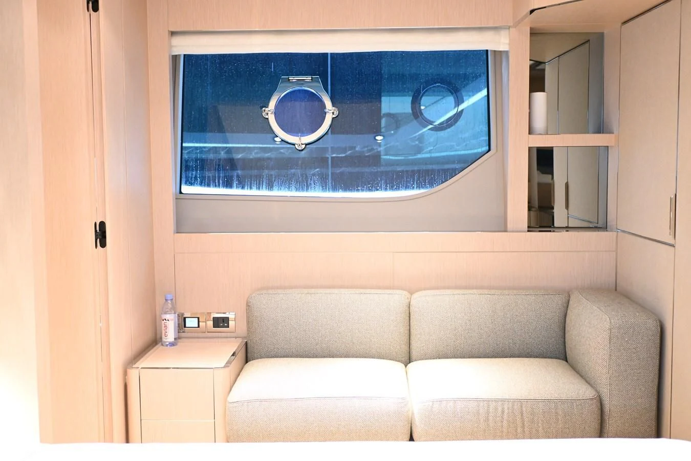 a couch and a window in a room aboard JOYOUS JOURNEY Yacht for Sale