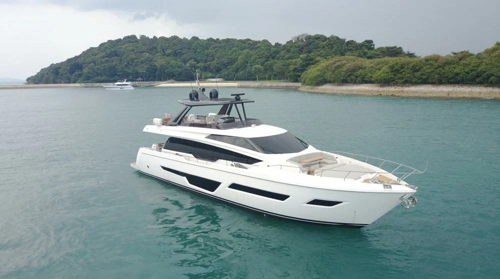 a white boat on the water aboard JOYOUS JOURNEY Yacht for Sale