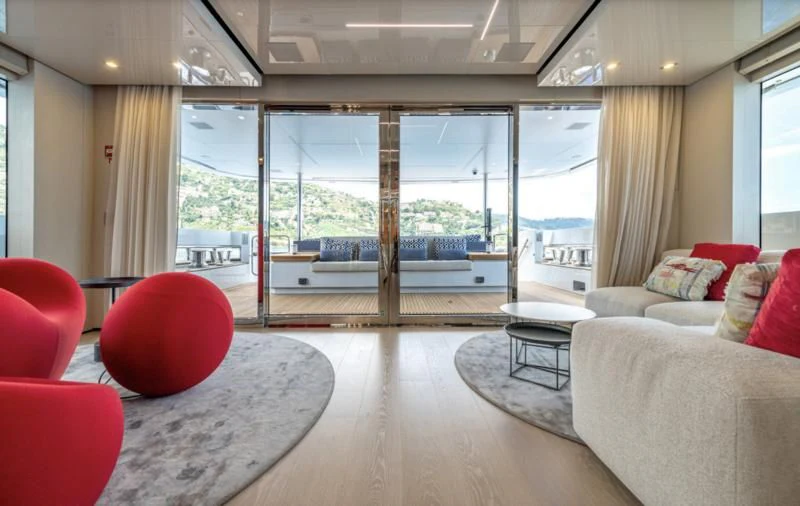 a living room with a large window aboard CARITA Yacht for Sale