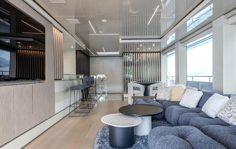 a living room with a couch and a table aboard CARITA Yacht for Sale