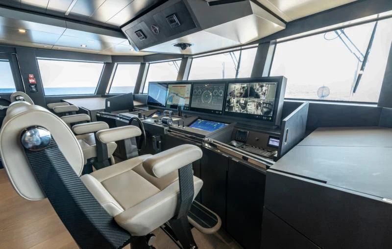 a room with many monitors and computers aboard CARITA Yacht for Sale