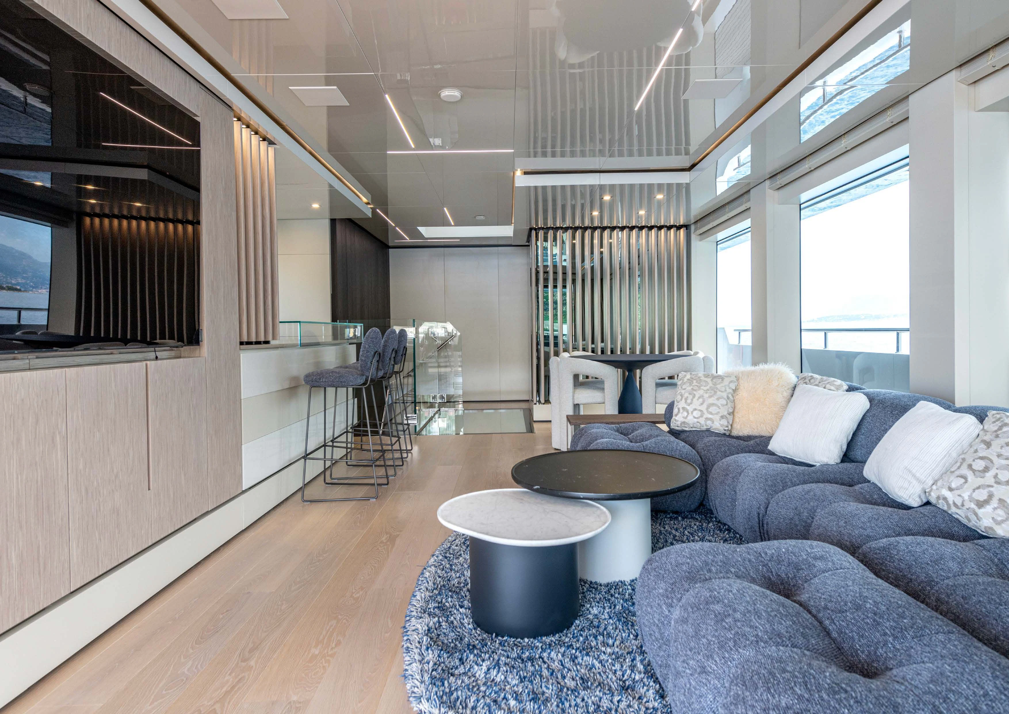 a living room with a couch and a table aboard CARITA Yacht for Sale