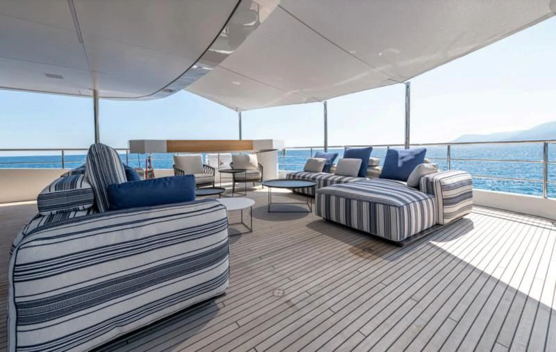 a large living room with a large balcony aboard CARITA Yacht for Sale