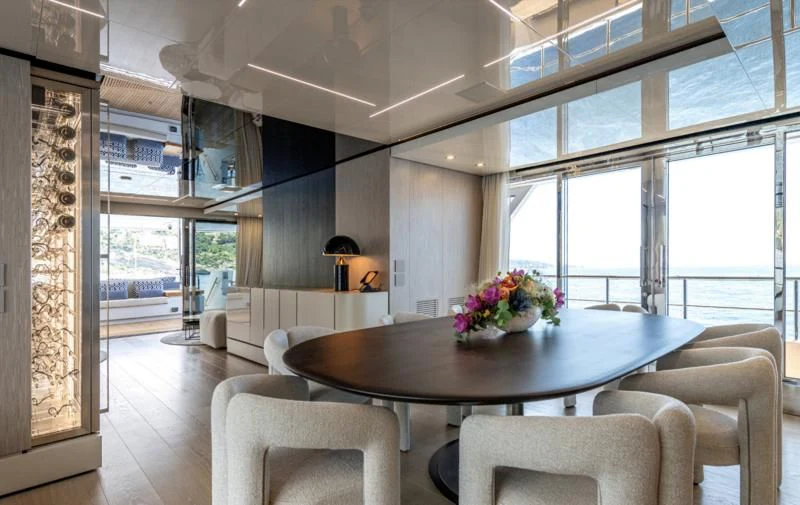 a large room with a table and chairs aboard CARITA Yacht for Sale