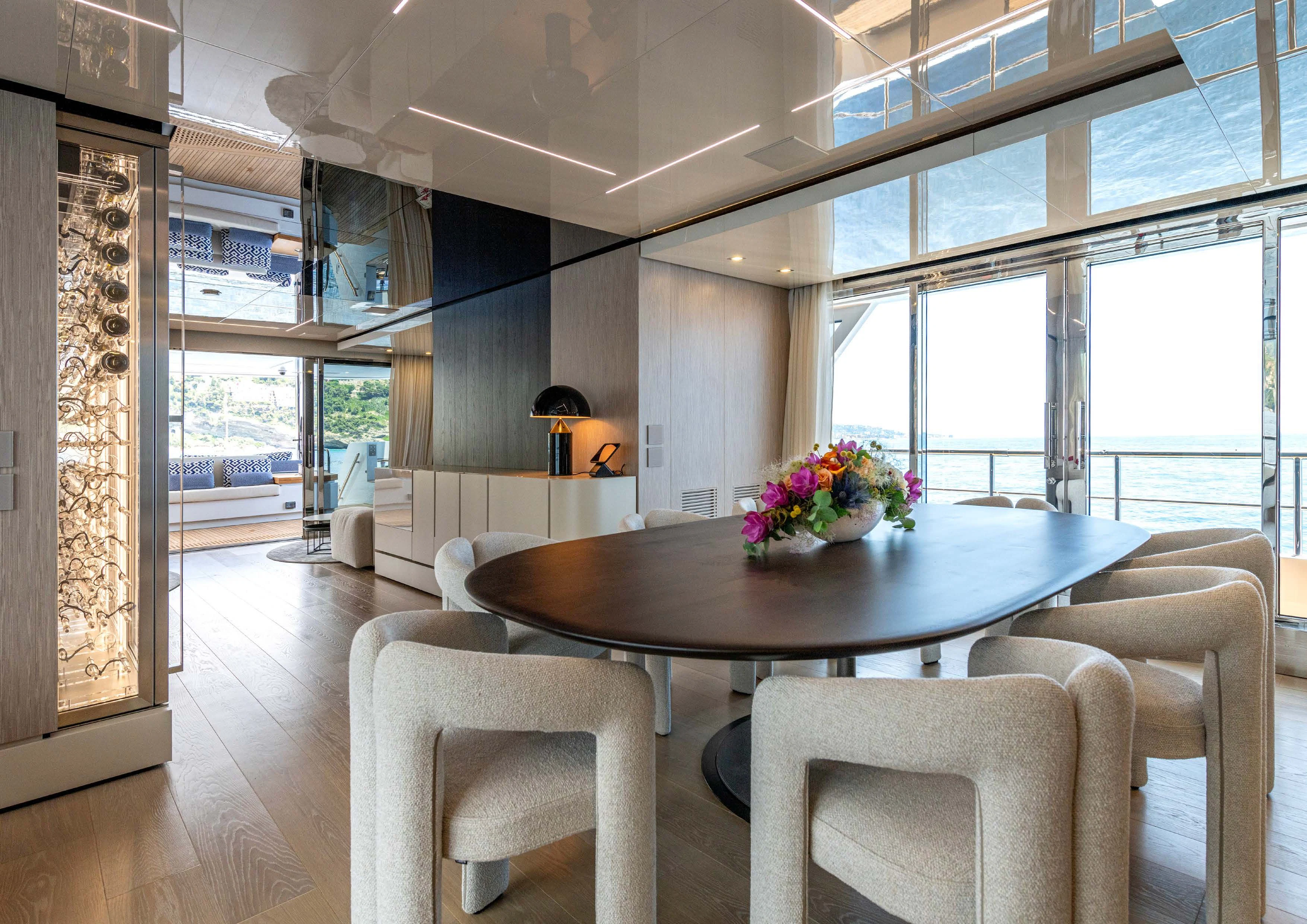 a room with a table and chairs aboard CARITA Yacht for Sale