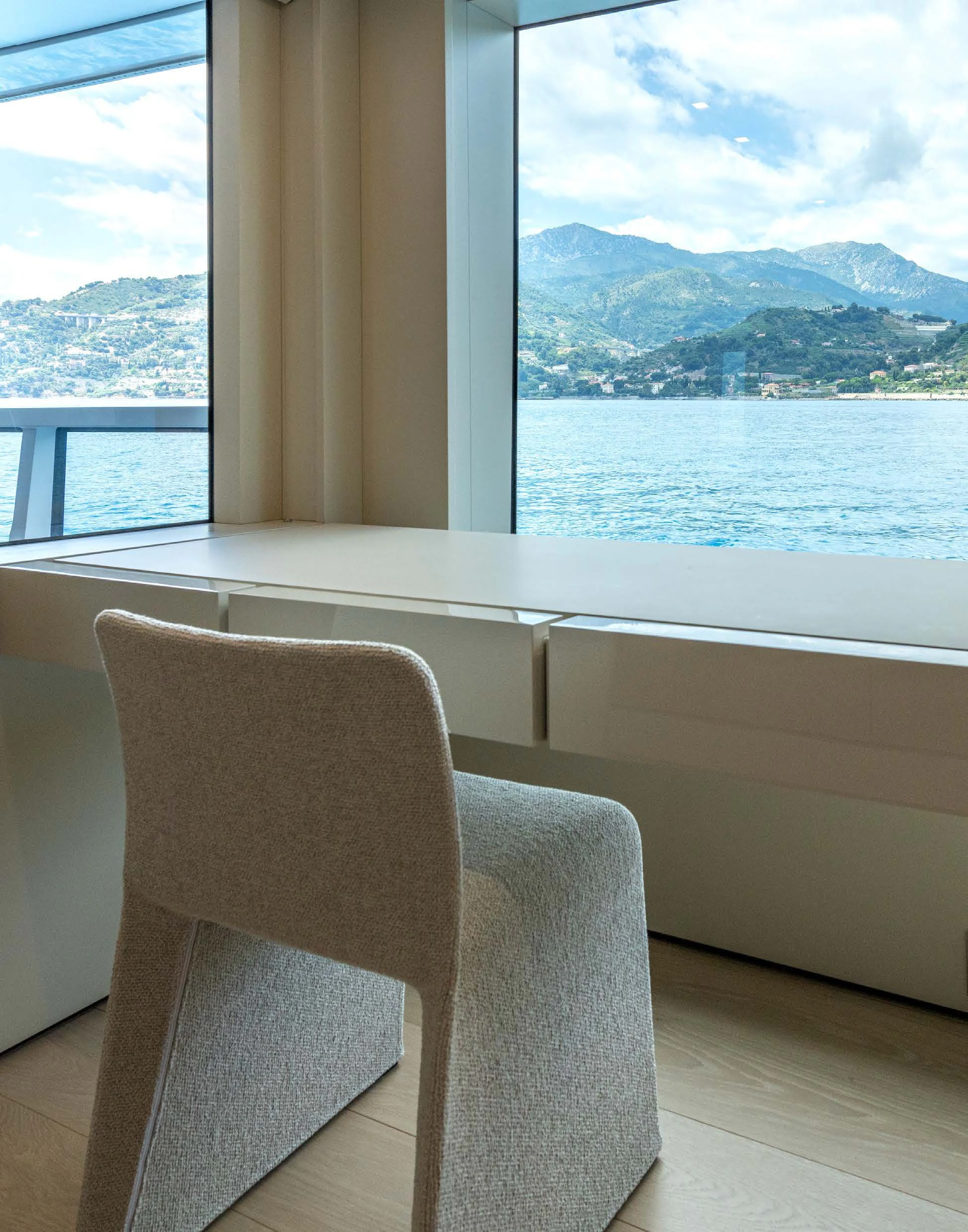 a room with a view of the ocean and mountains aboard CARITA Yacht for Sale