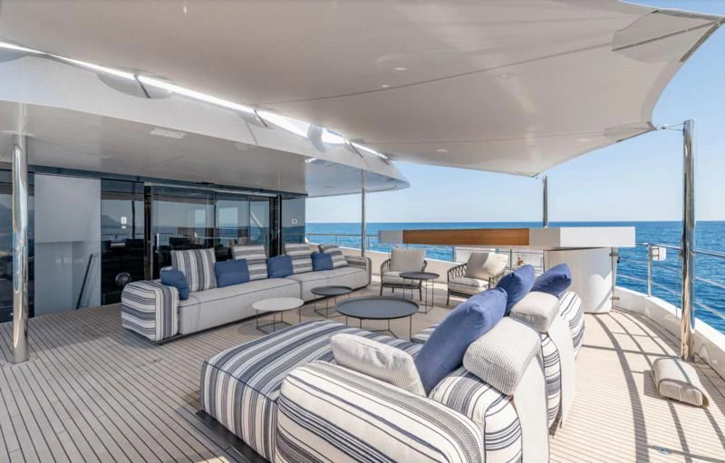 a large living room with a large balcony aboard CARITA Yacht for Sale