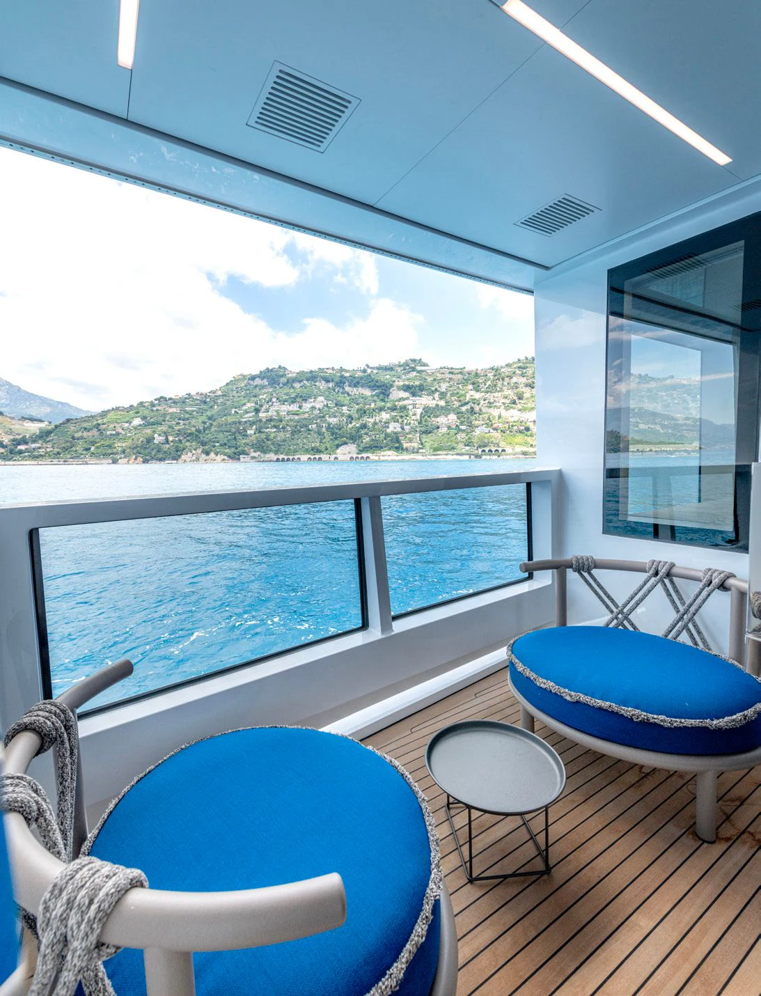 a room with a view of the mountains and water aboard CARITA Yacht for Sale