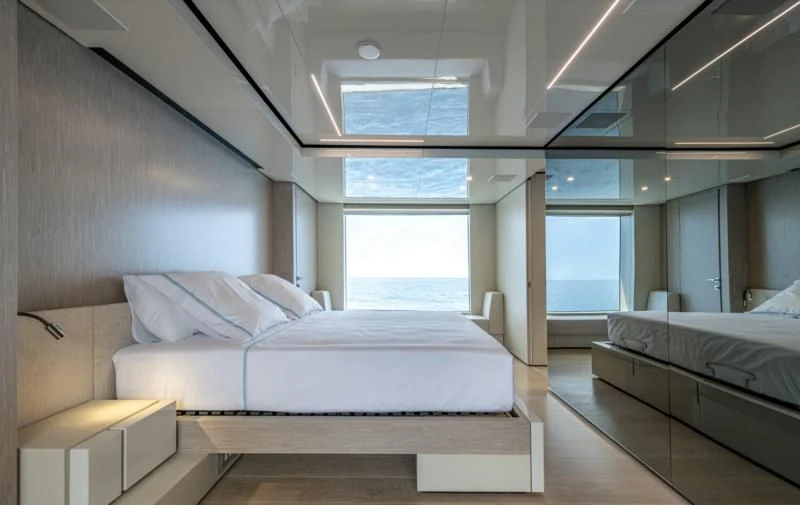a room with a bed and a couch aboard CARITA Yacht for Sale