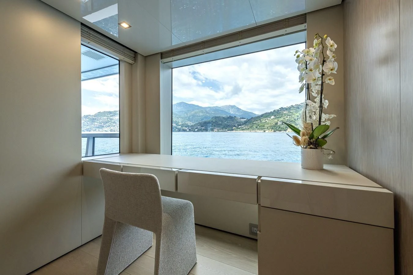 a room with a window and chairs aboard CARITA Yacht for Sale
