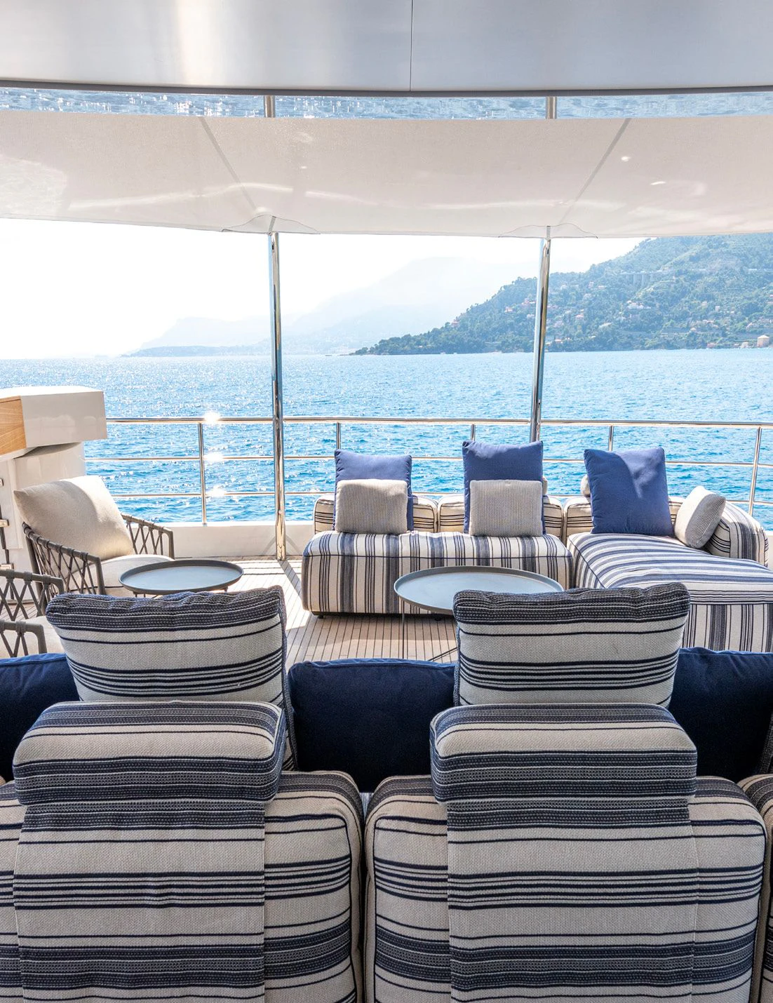 a room with a view of the ocean and mountains aboard CARITA Yacht for Sale