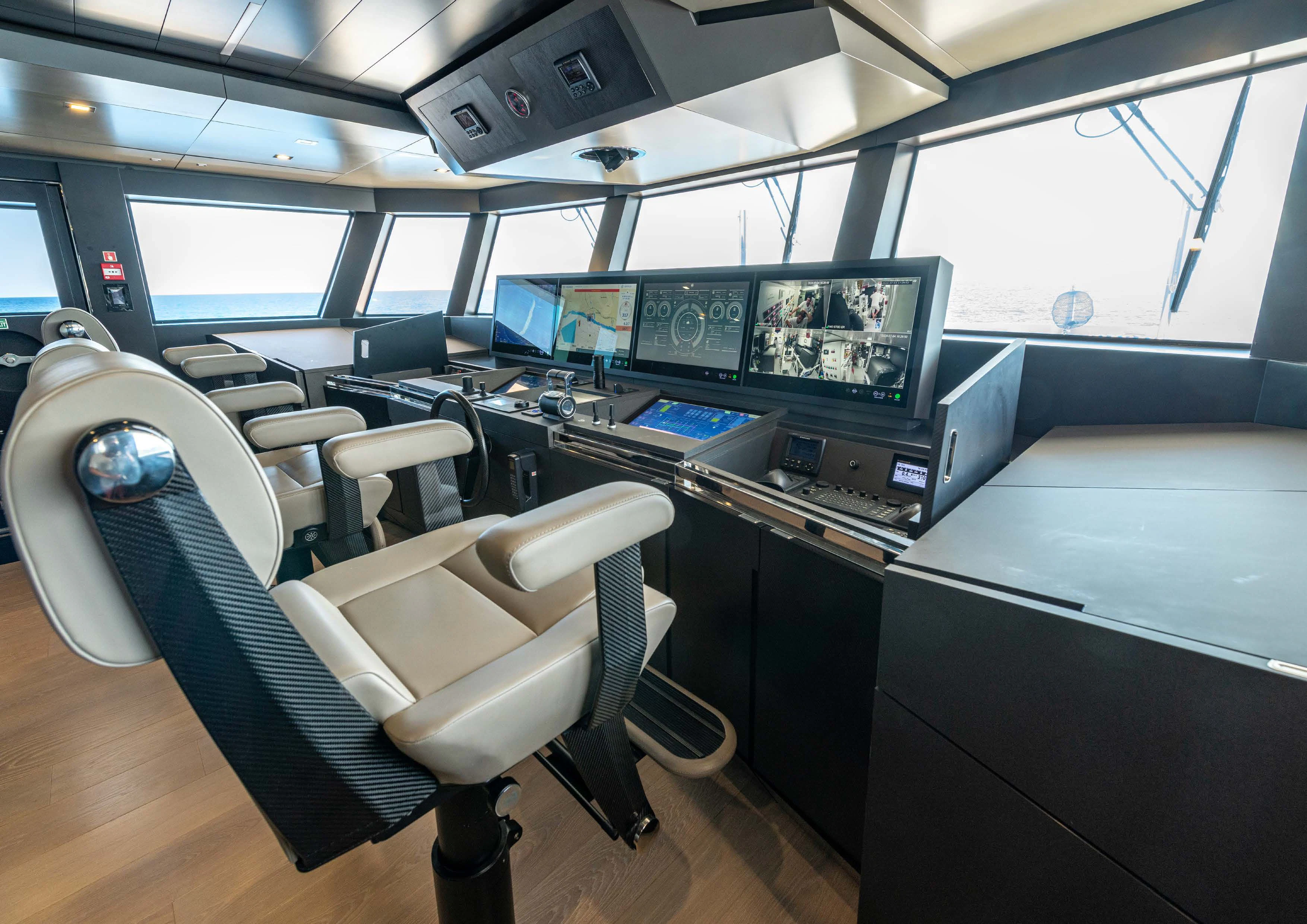 a room with many monitors and computers aboard CARITA Yacht for Sale