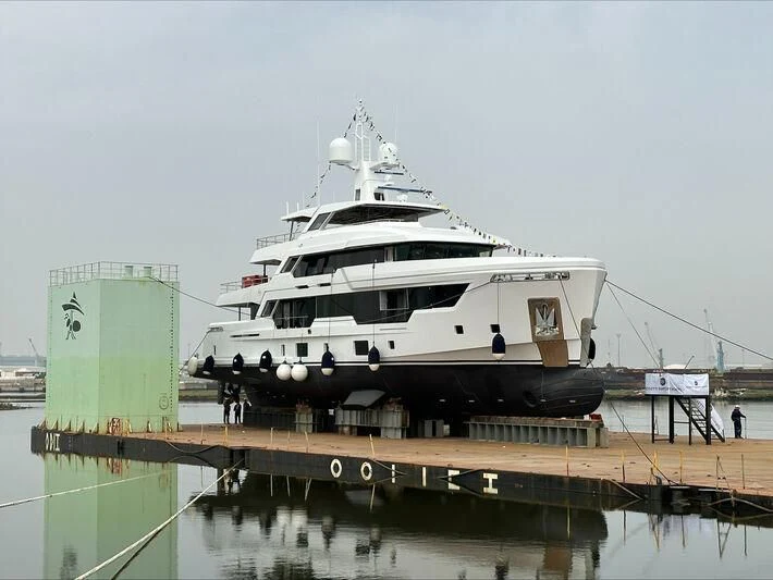 a large white boat docked at a pier aboard CARITA Yacht for Sale