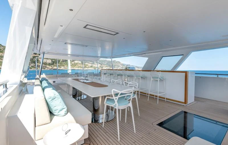 a room with a table chairs and a large window aboard CARITA Yacht for Sale