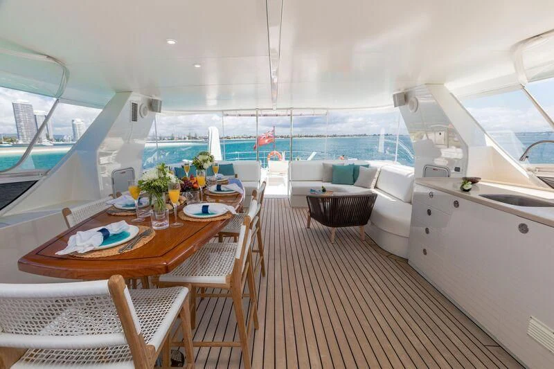 a boat with a table and chairs aboard TEXAS T Yacht for Sale