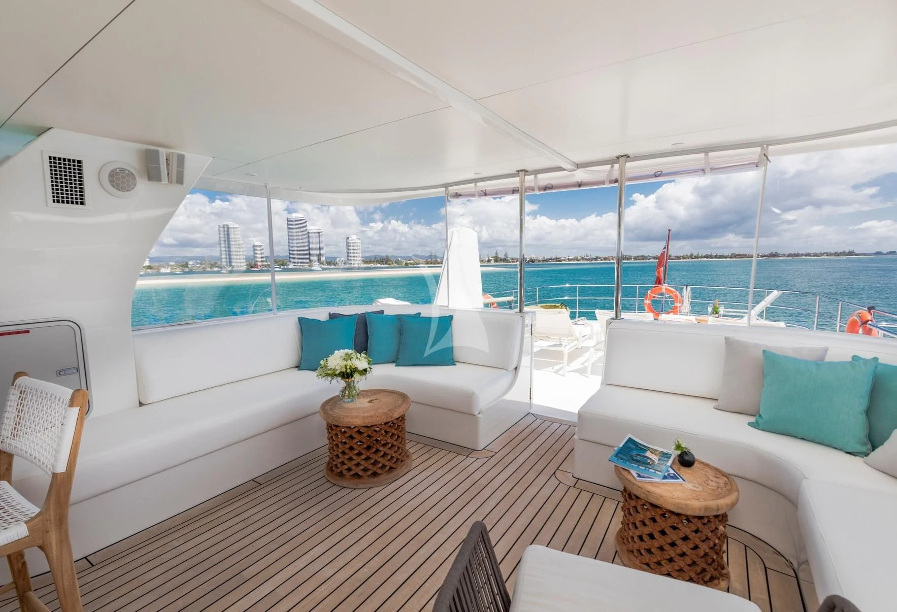 a large white lounge chair next to a large window overlooking a large body of water aboard TEXAS T Yacht for Sale