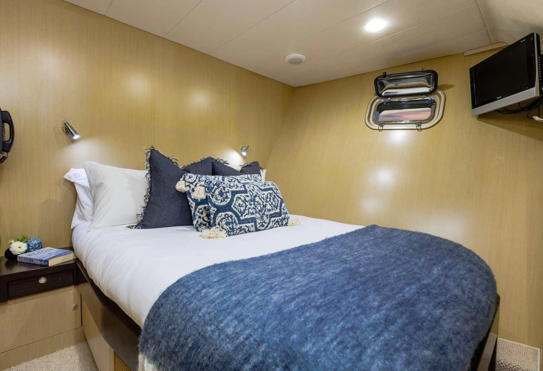 a bed with blue sheets aboard TEXAS T Yacht for Sale