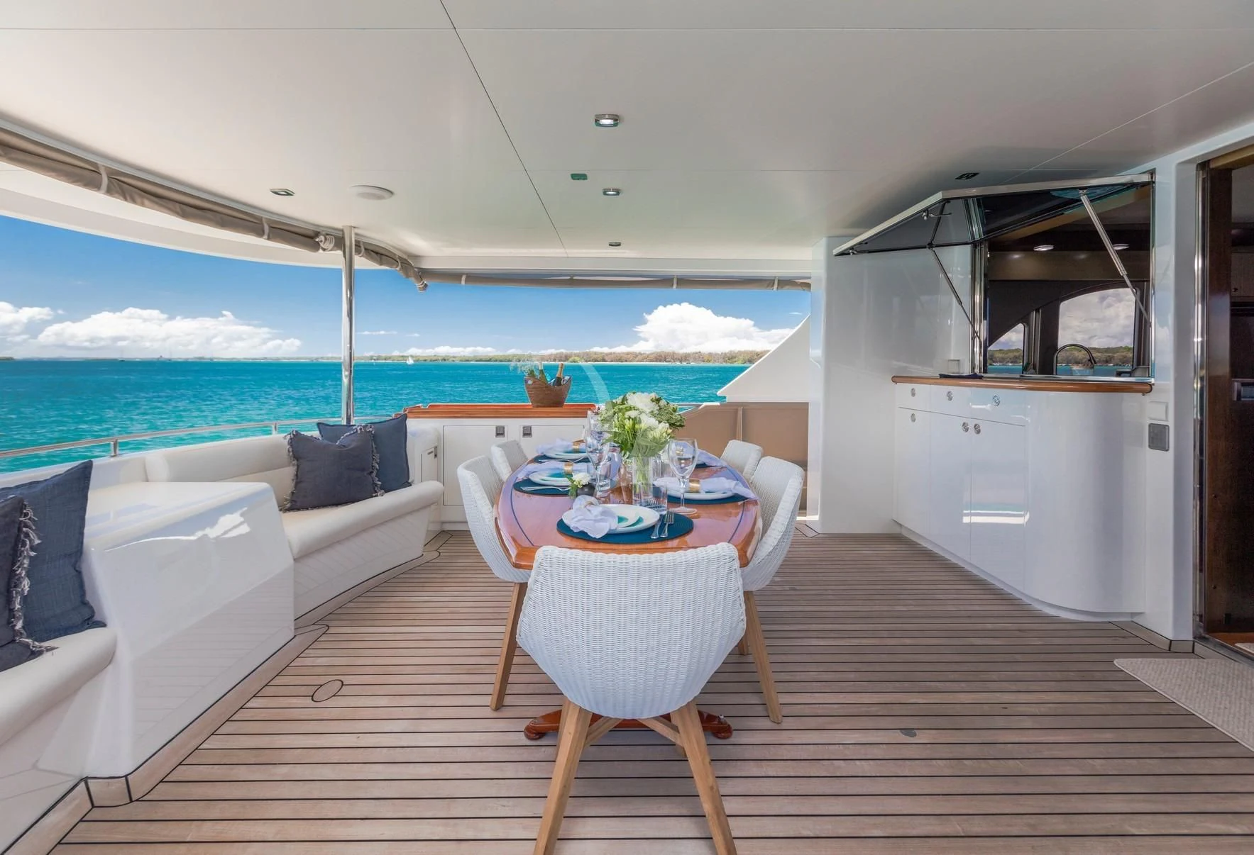 a living room with a table and chairs aboard TEXAS T Yacht for Sale