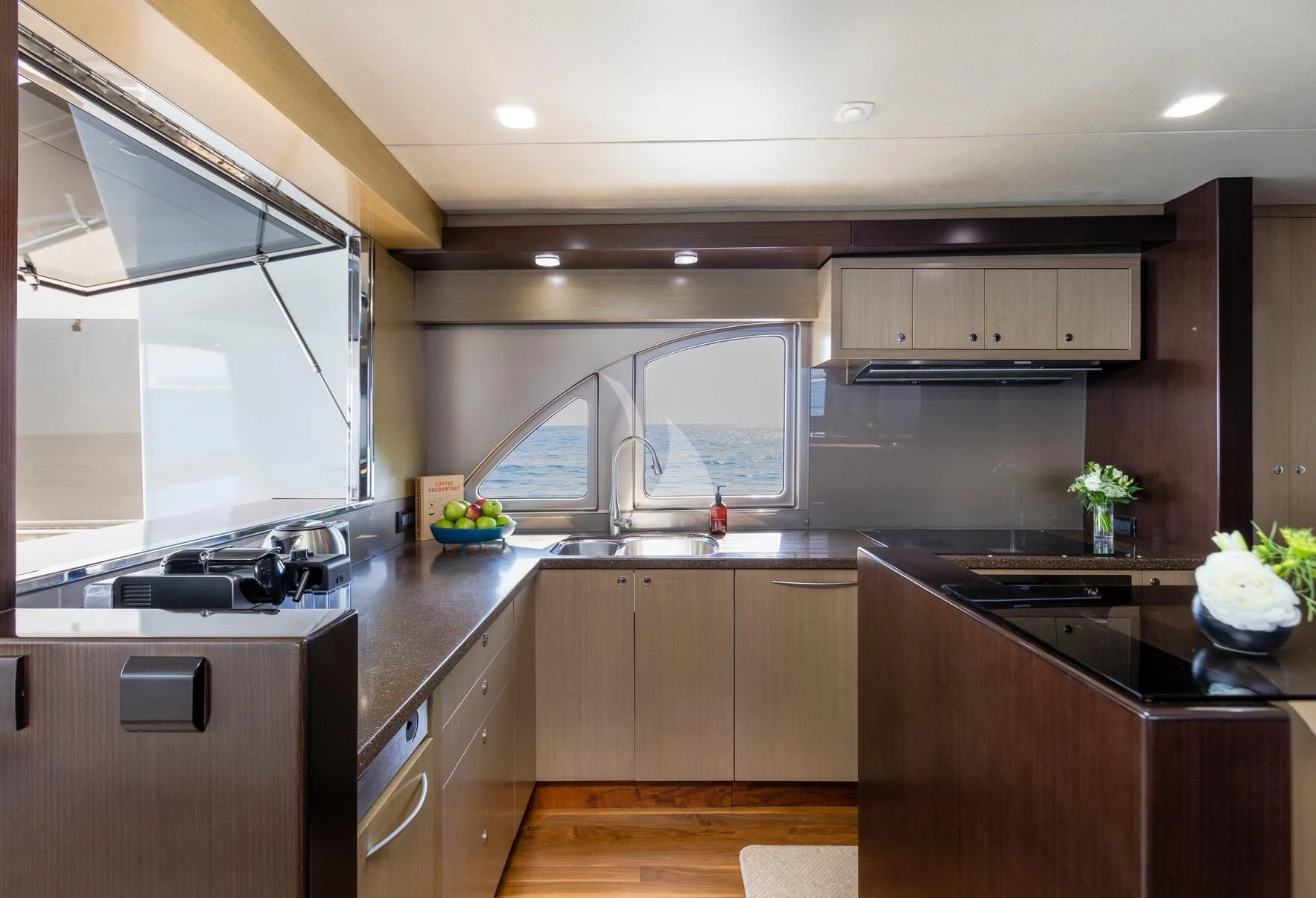 a kitchen with a large window aboard TEXAS T Yacht for Sale