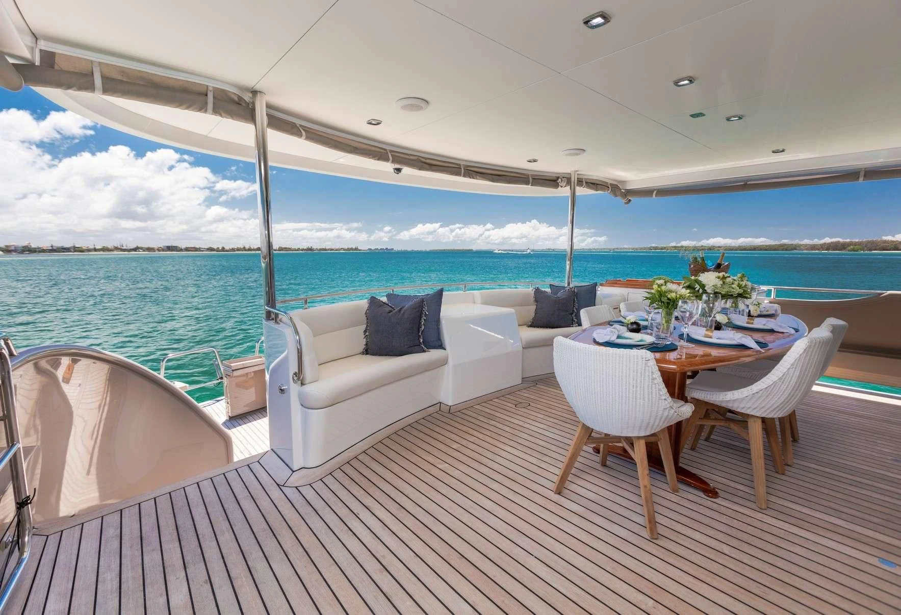 a large white lounge chair on a deck overlooking a large body of water aboard TEXAS T Yacht for Sale