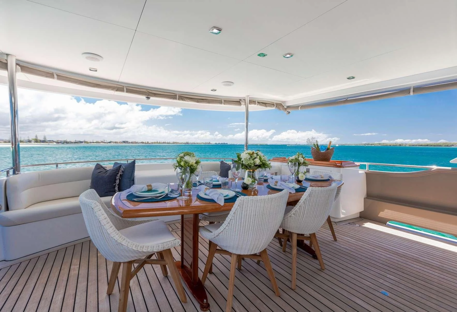 a table and chairs on a deck aboard TEXAS T Yacht for Sale