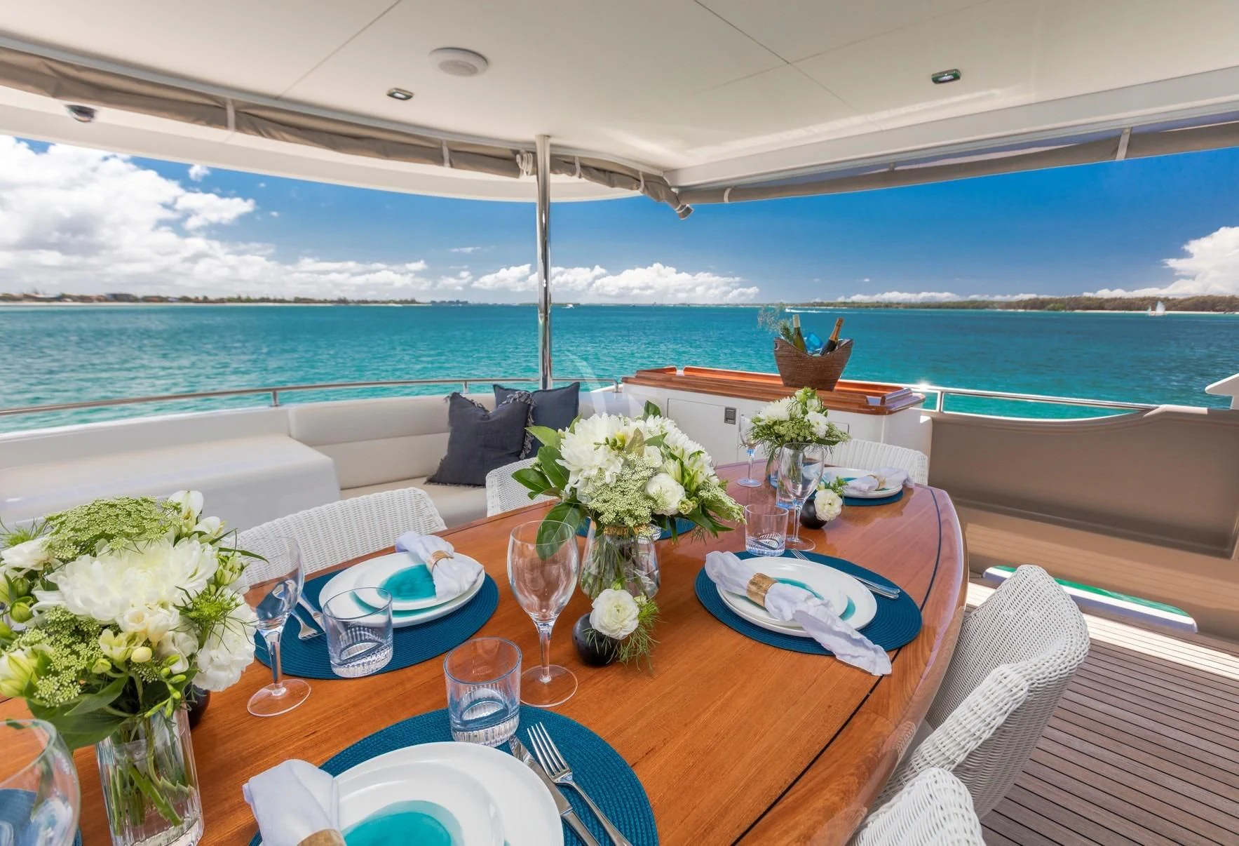 a table with flowers and plates on it aboard TEXAS T Yacht for Sale