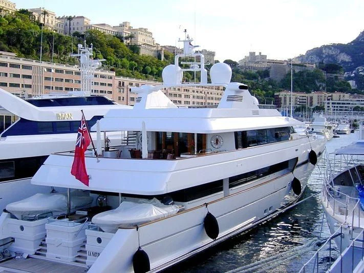 a large white boat in a harbor aboard TURQUOISE Yacht for Sale
