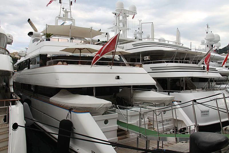 a boat with a flag on the deck aboard TURQUOISE Yacht for Sale