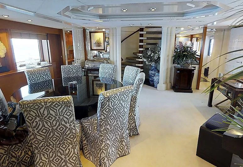 a living room with chairs and a fireplace aboard TURQUOISE Yacht for Sale
