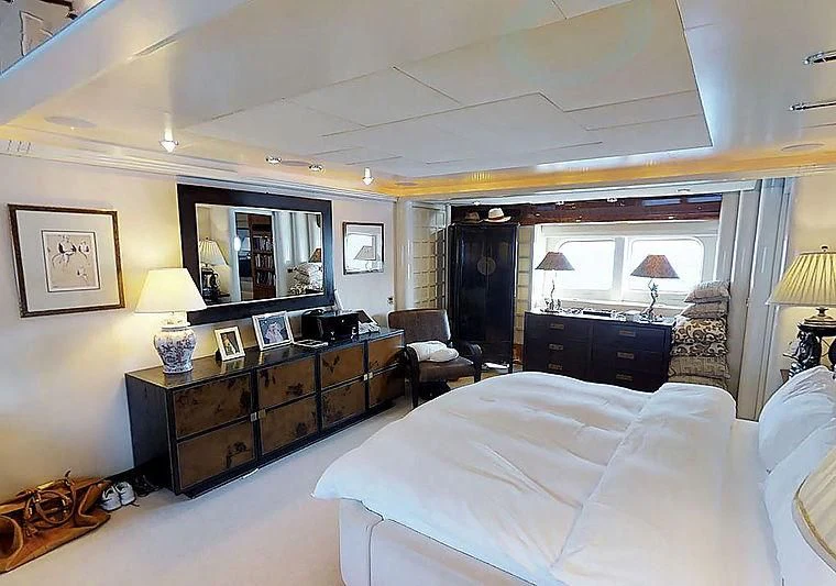 a bedroom with a bed and a desk aboard TURQUOISE Yacht for Sale