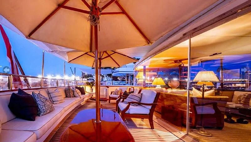 a room with a bed and a couch and a large umbrella aboard TURQUOISE Yacht for Sale