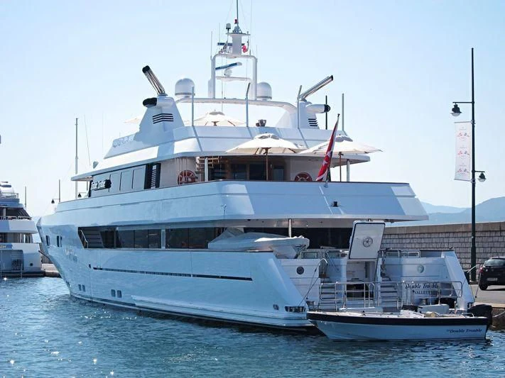 a large white boat with a flag on it aboard TURQUOISE Yacht for Sale