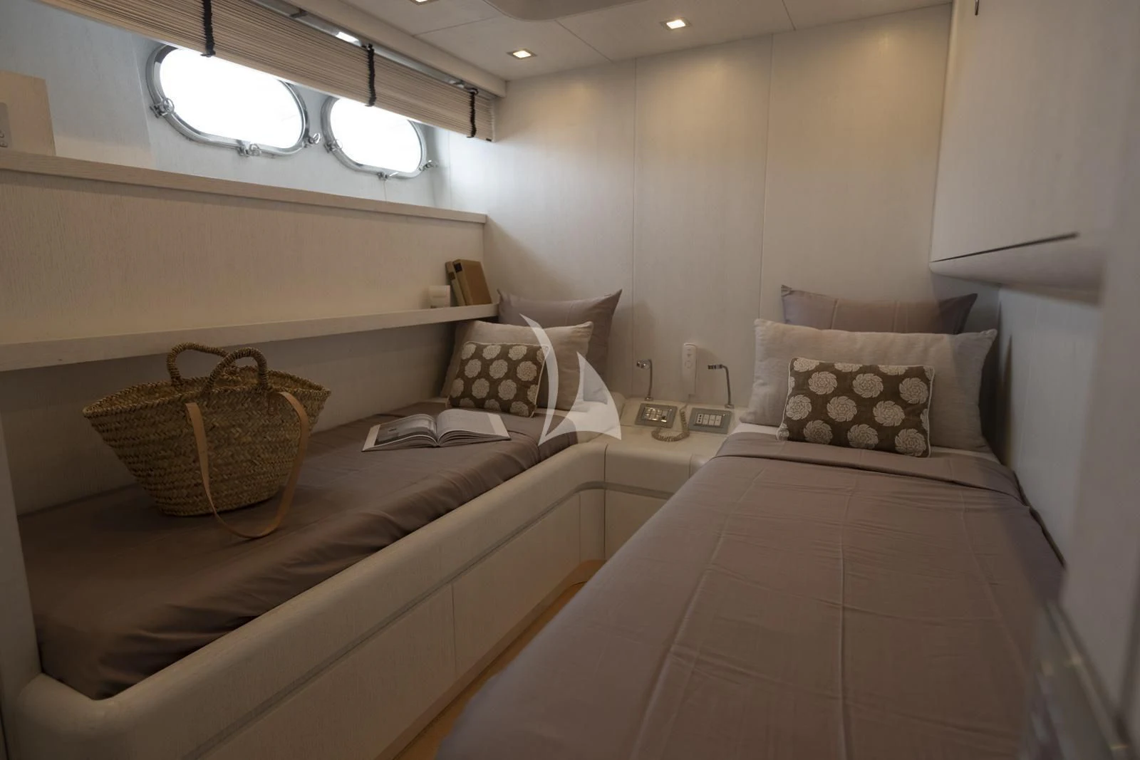a couple of beds in a hotel room aboard XUMI Yacht for Charter