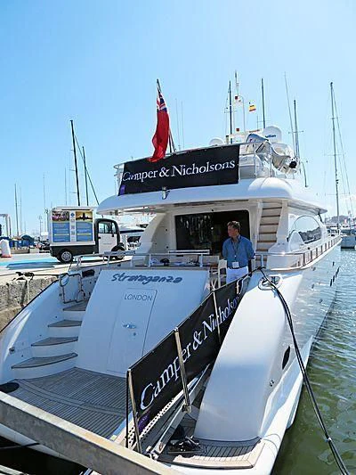 a boat with a person standing on the deck aboard XUMI Yacht for Charter