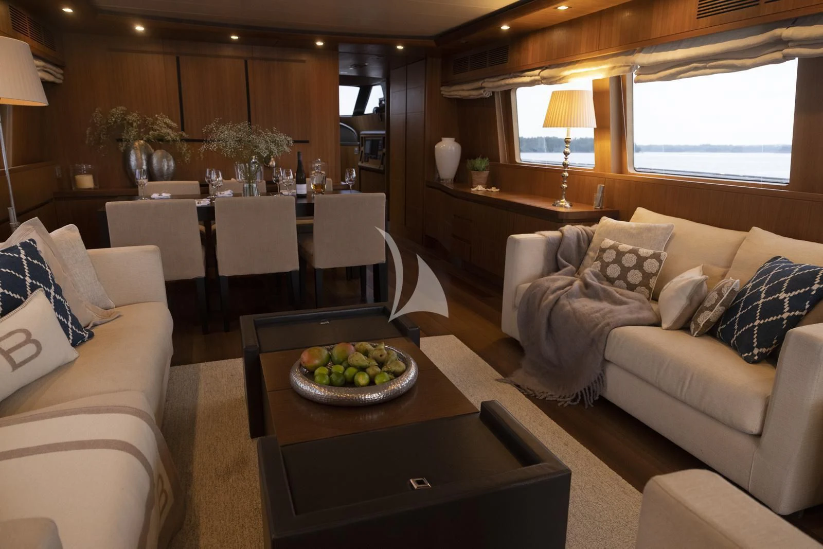 a living room with a couch and a table aboard XUMI Yacht for Charter