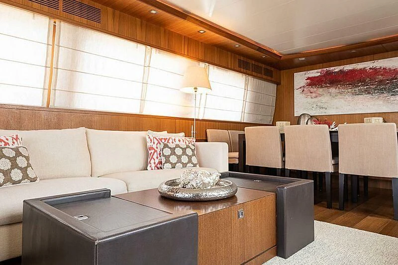 a living room with a couch and a table aboard XUMI Yacht for Charter