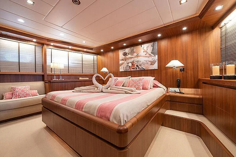 a room with a bed and a window aboard XUMI Yacht for Charter
