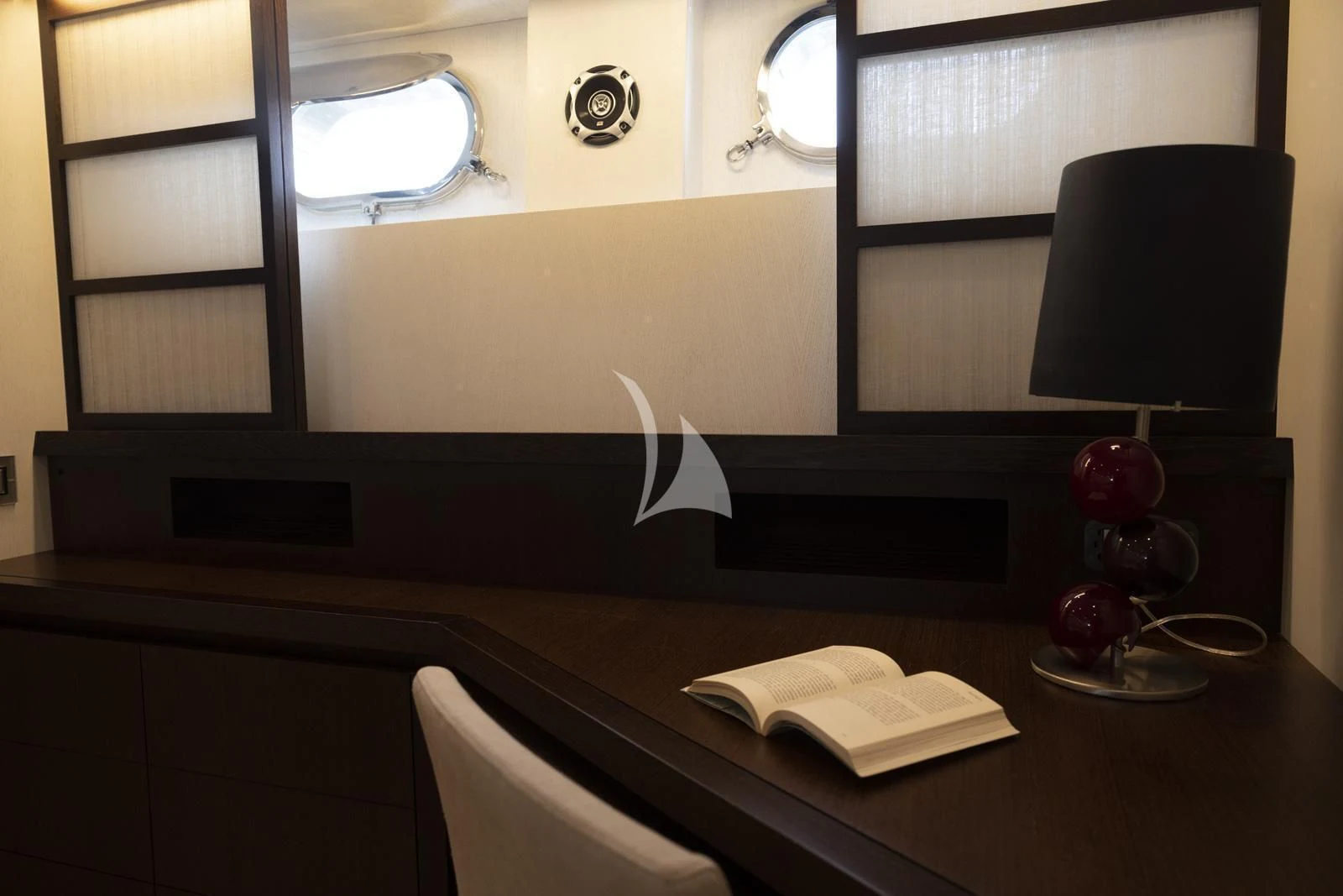 a lamp on a desk aboard XUMI Yacht for Charter