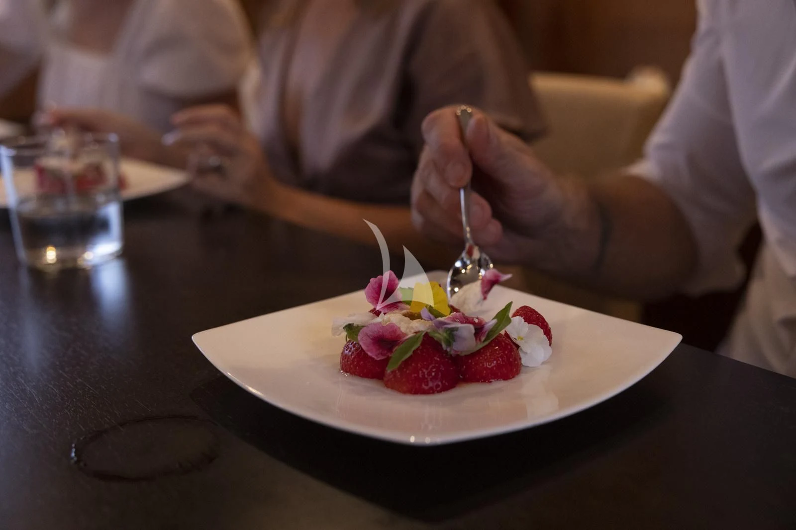 a person eating a dessert aboard XUMI Yacht for Charter
