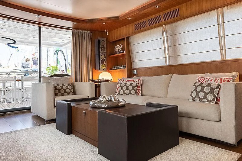 a living room with a large window aboard XUMI Yacht for Charter
