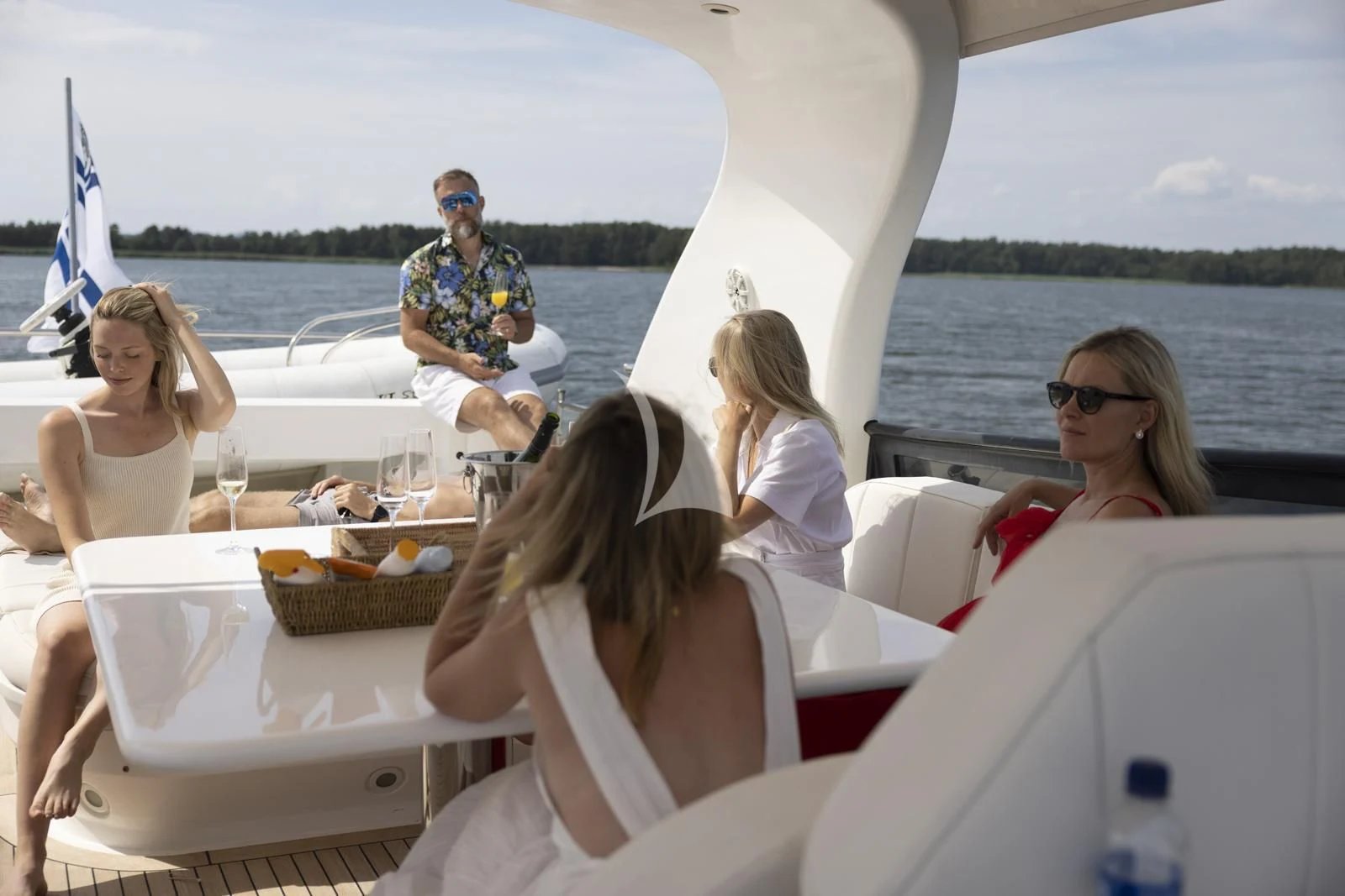 a group of people sitting on a boat aboard XUMI Yacht for Charter