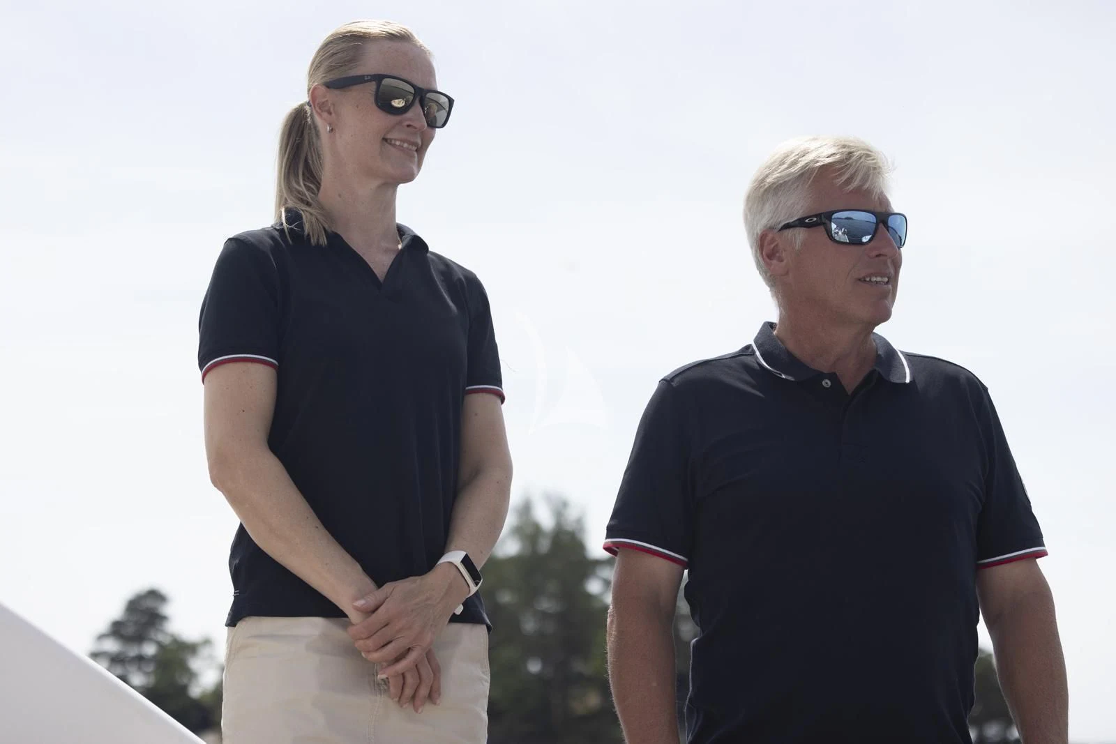 a man and a woman smiling aboard XUMI Yacht for Charter