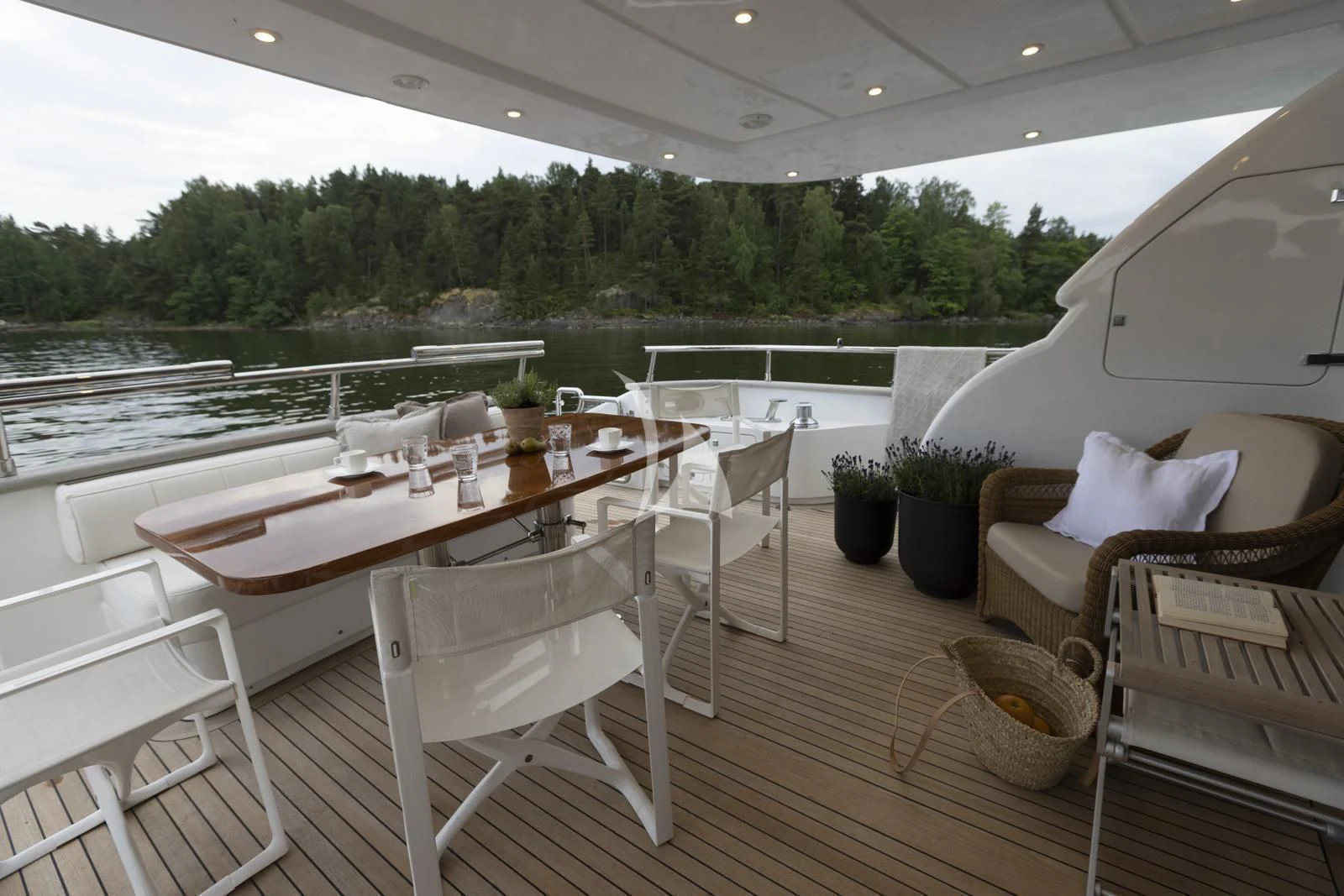 a table and chairs on a deck aboard XUMI Yacht for Charter