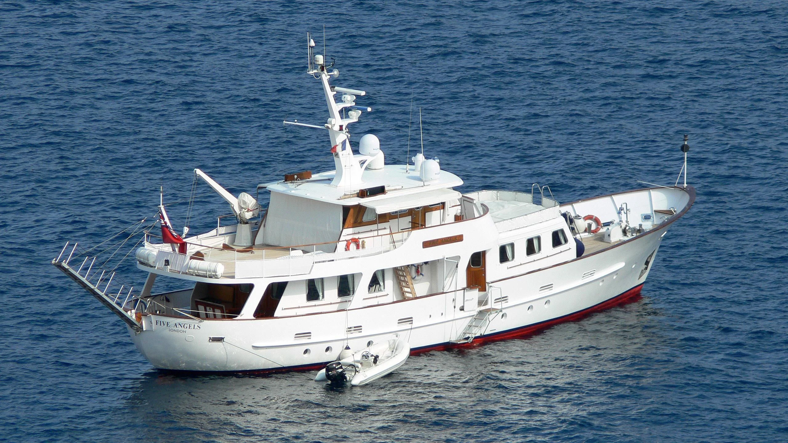 a white boat in the water aboard FIVE ANGELS Yacht for Sale