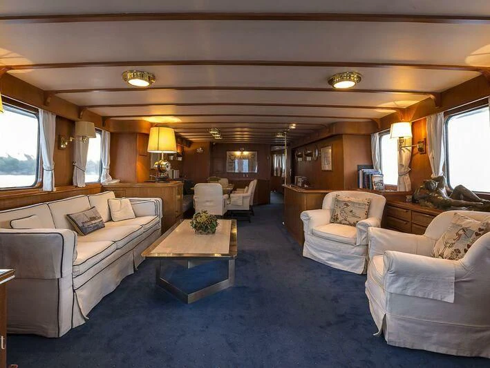 a living room with a couch and a coffee table aboard FIVE ANGELS Yacht for Sale