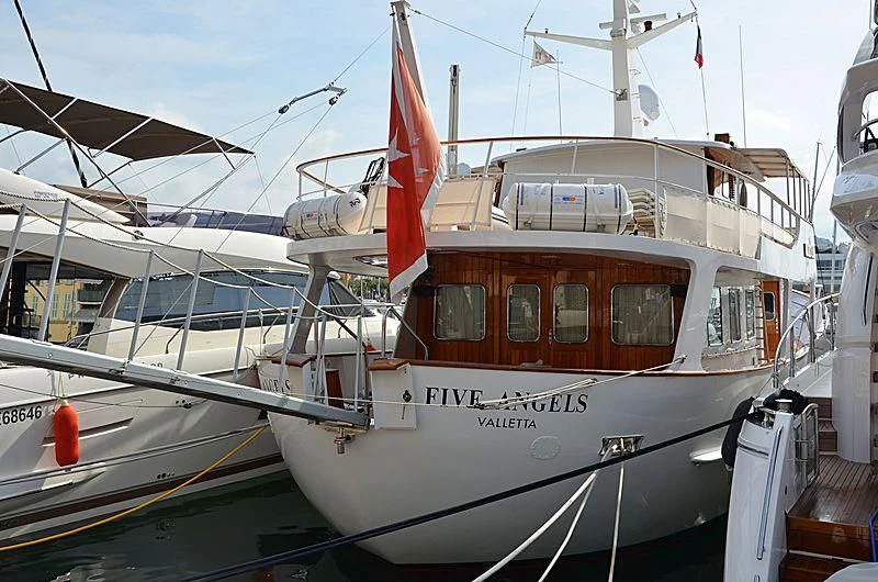 a boat with a flag on the front aboard FIVE ANGELS Yacht for Sale