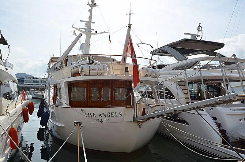 a large white boat with a red stripe on it aboard FIVE ANGELS Yacht for Sale