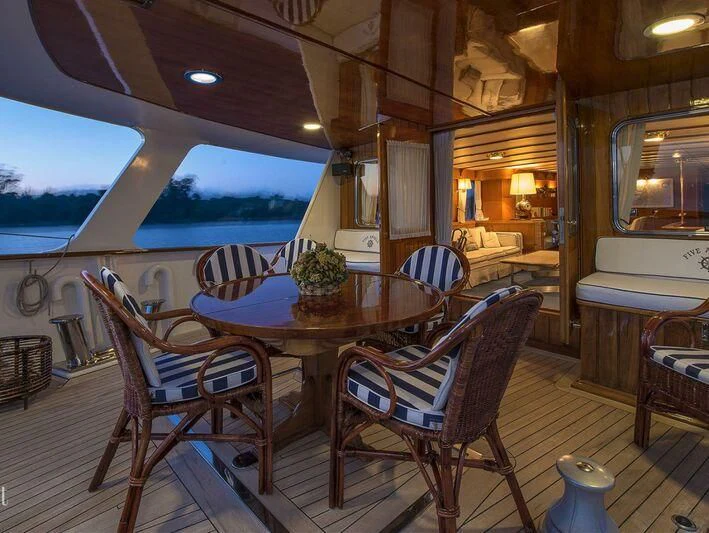 a table and chairs on a boat aboard FIVE ANGELS Yacht for Sale
